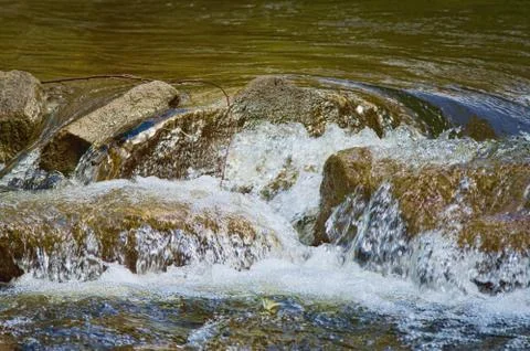 Waterfalling on rocks in stream Stock Photos