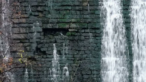 Waterfalls along an old brick wall Old micro hydro power plant Stock Footage 74012143