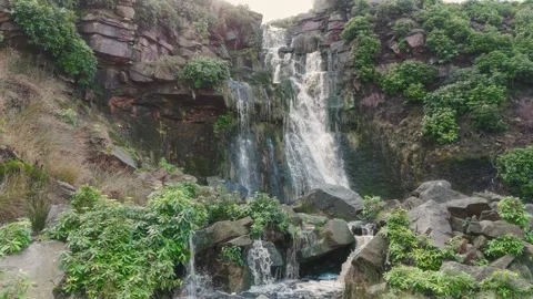Waterfalls cascade down rugged, mossy rocks Stock-Footage 342942425
