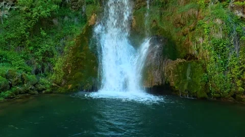 Waterfalls cascade over mossy rocks into a deep green pool. Veliki Buk, Serbia. Vídeos de archivo 336888693