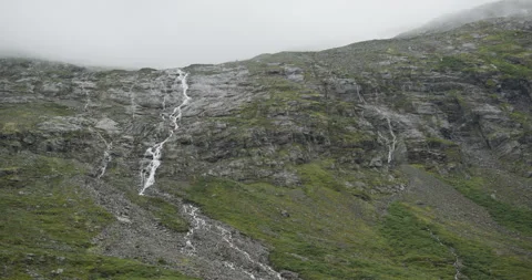 Waterfalls cascading down a rocky mountain in norway Stock Footage 326353385