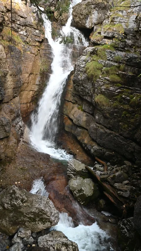 Waterfalls cascading in a gorge, in the shadow, vertical shot Stock Footage 260872891