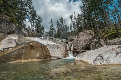Waterfalls of Cold stream in Great Cold Valley in High Tatras, Slovakia. Cloudy Stock Photos