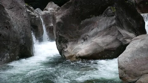 Waterfalls flow through huge rocks Stock Footage 134305159