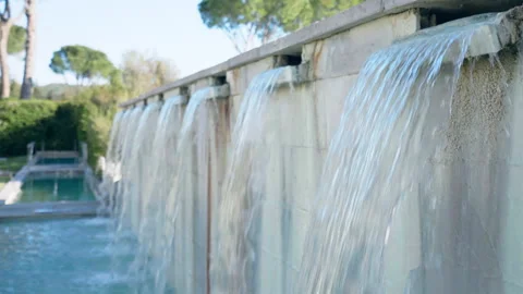 Waterfalls from high marble wall on the backyard of luxury hotel complex 스톡 동영상 264770318
