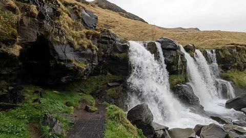 In this Waterfalls tranquil atmosphere, forest backdrops and picturesque scenery Stock Photos