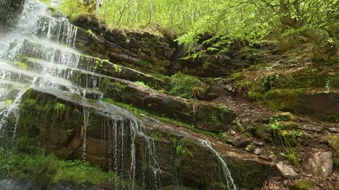 Waterfalls tumble down on mossy rock. Slowmotion. Tupavica Waterfall Stock Footage 335536053
