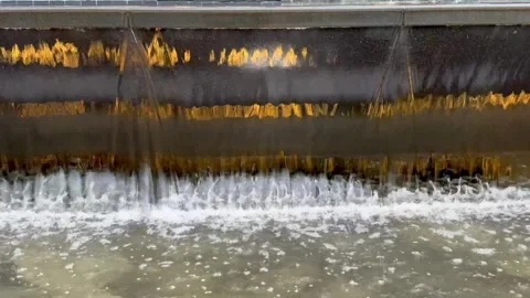 Waterflow and stream down a pond, water fountain with lighting effect 스톡 동영상 287602712