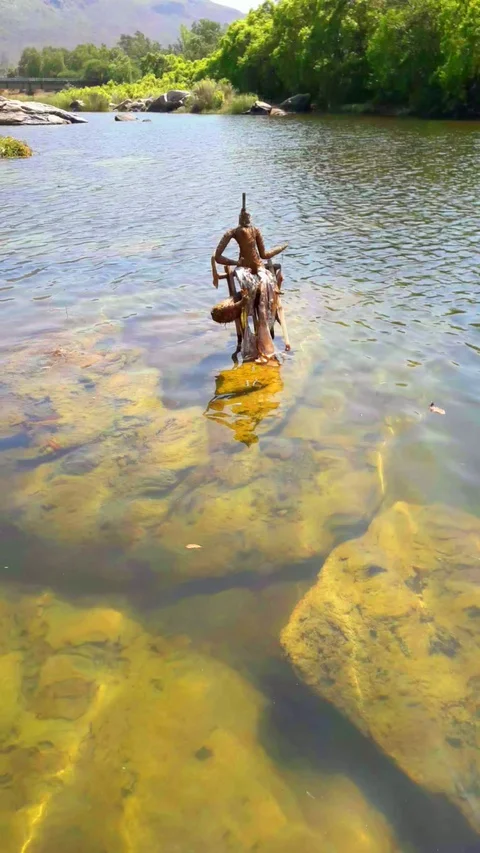 Waterflow in a river with God statue Stock Footage 127622407