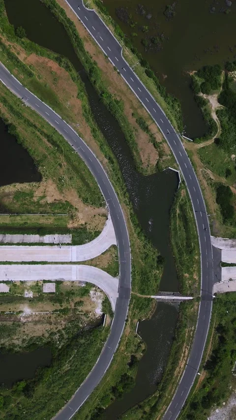 Waterfront Arch Bridge Linking Marshlands With Infrastructure Stock Footage 328018623
