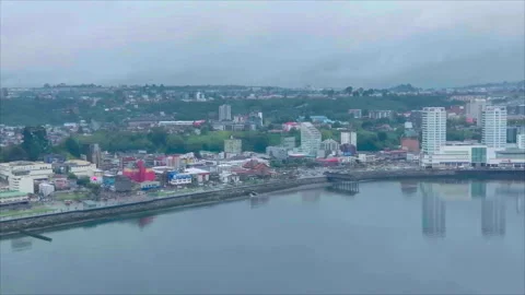 Waterfront with building reflections, drone advancing, Puerto Montt Vídeos de archivo 340994567