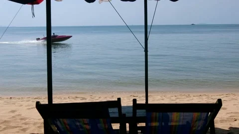 Waterfront landscape ocean view sunny beach bed on sand and banana boat, Pattaya Stock Footage 228722467