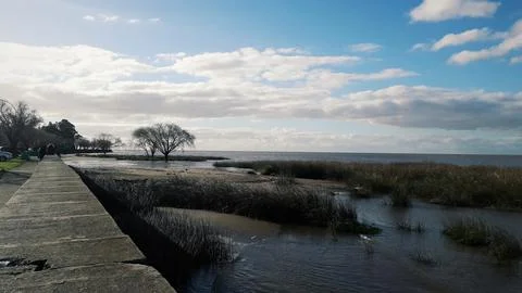 Waterfront of the river de la plata, blue sky with clouds Stock Photos