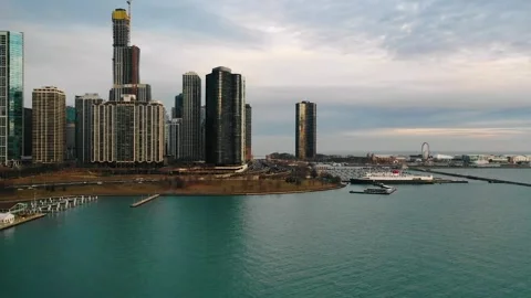 A waterfront scene featuring a large body of water and a pier with docked Stock Footage 294538692