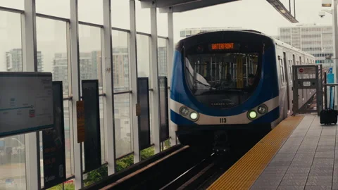 Waterfront Skytrain arriving at a station Stock Footage 244542186