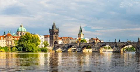 Waterfront view across the river Vltava to the Charles Bridge, Prague Stock Photos
