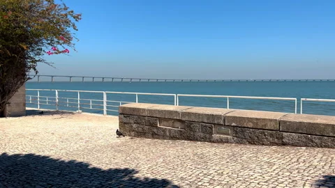 Waterfront walk with view of Vasco da Gama Bridge bridge seen during sunny day Stock-Footage 247948203