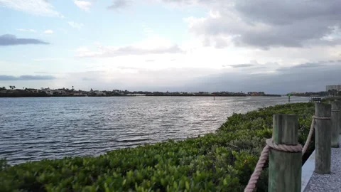 Waterfront Walking Path Along Scenic Coastal Lagoon at Sunset Stock Footage 340428094