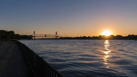 Waterfront Walkway with Bridge in Background Sunset Timelapse to Night Stock Footage 91984703