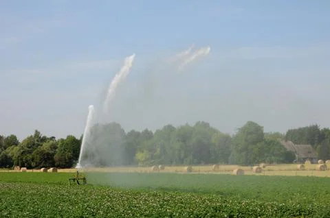 Watering in a field Stock Photos