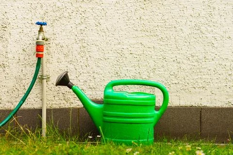 Watering green can on garden plot Stock Photos