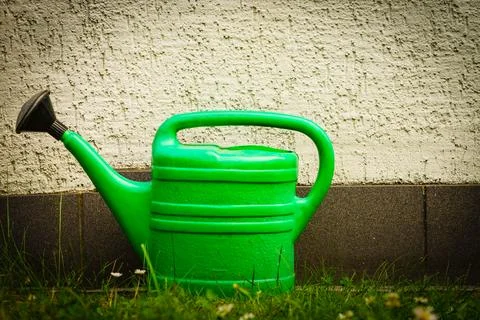 Watering green can on garden plot Stock Photos