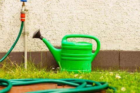 Watering green can on garden plot Stock Photos