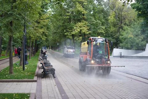 Watering machine in the park. Stock Photos