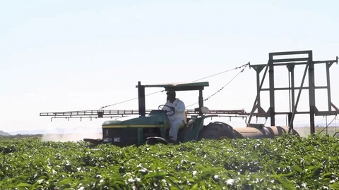 Watering plot with tractor Vídeos de archivo 130042005