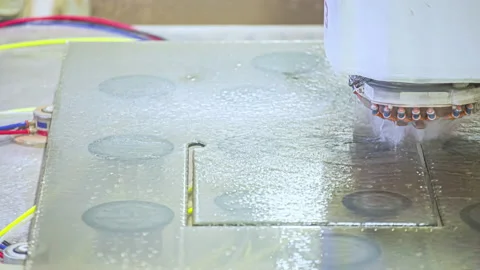 A waterjet cutting machine cuts out a rectangle shape in plastic, Stock Footage 210109458