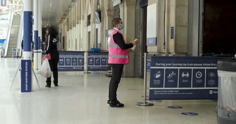 Waterloo Station, providing hand sanitiser to commuters Stock Footage 133801273