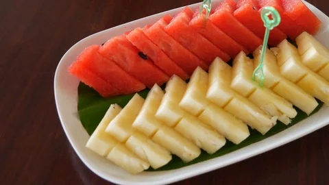 Watermelon and pineapple A piece on a white plate Video stock 79250495