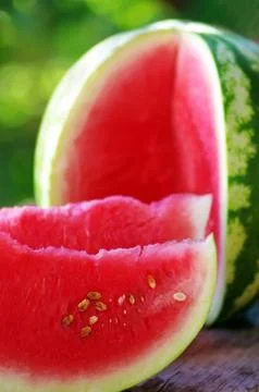 Watermelon and slice on table Stock Photos