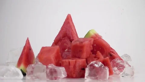 Watermelon Cubes Falling on the Table Stock Footage 79530838