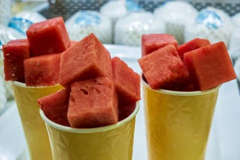 Watermelon Cubes placed in serving paper cups for sale in a fresh fruit shop Stock Photos