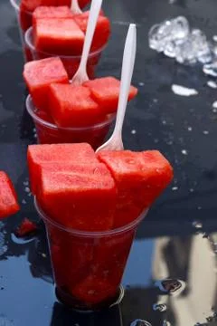 Watermelon in a cup with a plastic fork Stock Photos