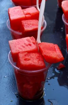Watermelon in a cup with a plastic fork Stock Photos