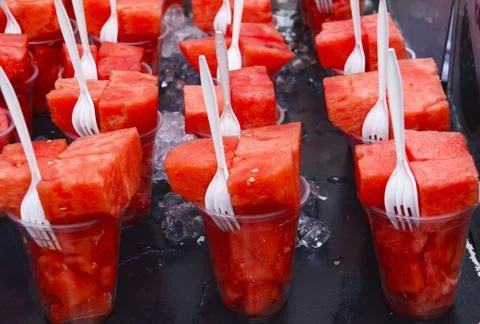 Watermelon in a cup with a plastic fork Stock Photos