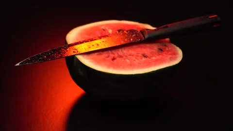 A watermelon cut in two halves with a knife Stock Footage 283720077