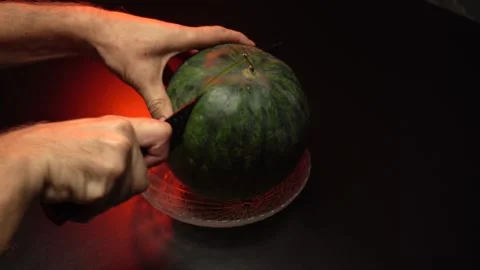 A watermelon cut in two halves with a knife Stock Footage 283731767