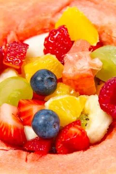 Watermelon filled with fresh fruit salad. summer fresh fruits salad close-up. Stock Photos