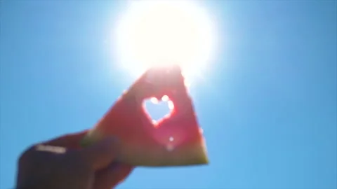 Watermelon in hand against the sky. Selective focus. Stock Footage 213873574