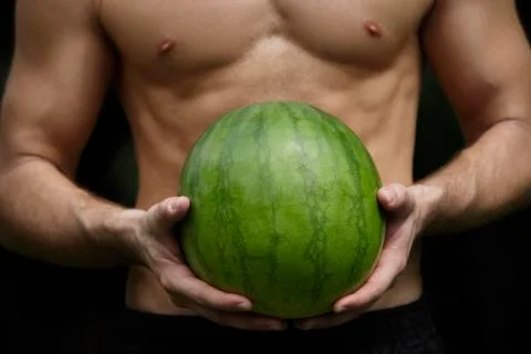Watermelon held by hands of man Stock Photos