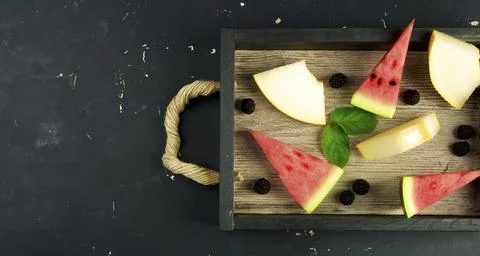 WATERMELON MELON BLACKBERRIES MINT IN THE BOX IN THE BACKGROUND. THREE PIECES OF Stock Photos