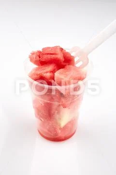 Watermelon pieces in plastic glass with fork Stock Photos