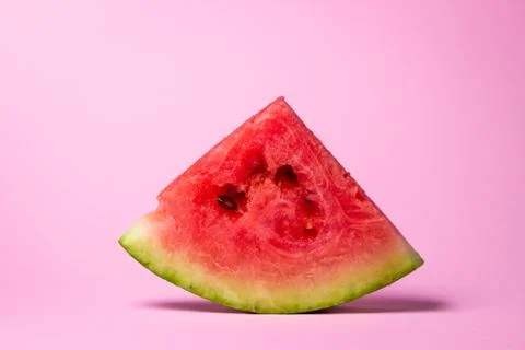 Watermelon on a pink background. Cut off a slice of watermelon. Fotos de archivo