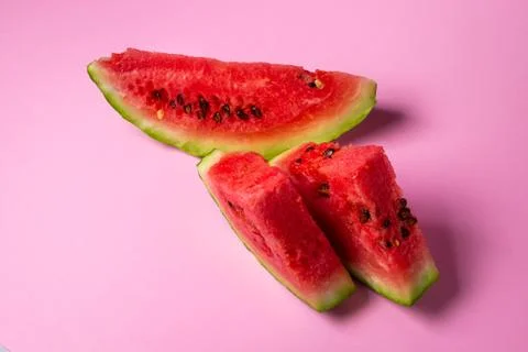 Watermelon on a pink background. Cut off a slice of watermelon. Stock Photos