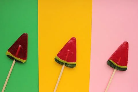 Watermelon popsicle on colored backdrop. Stock Photos