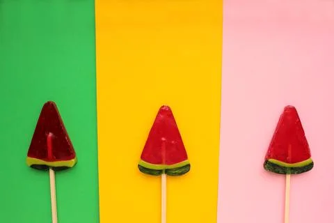 Watermelon popsicle on colored backdrop. Stock Photos