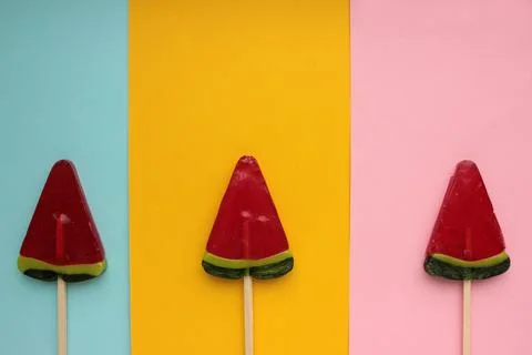 Watermelon popsicle on colored backdrop. Stock Photos